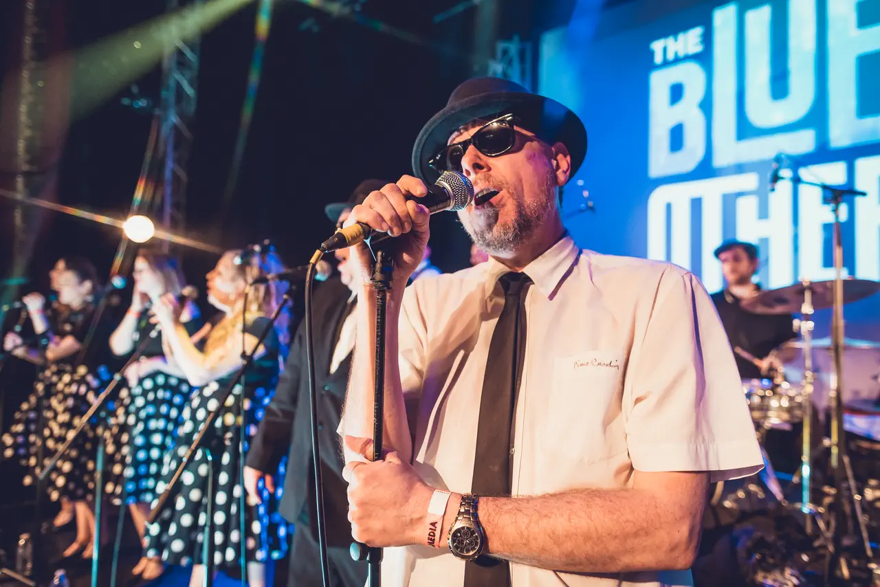 The Blues Others' vocalist in trilby and shades singing with the polka-dot backing singers